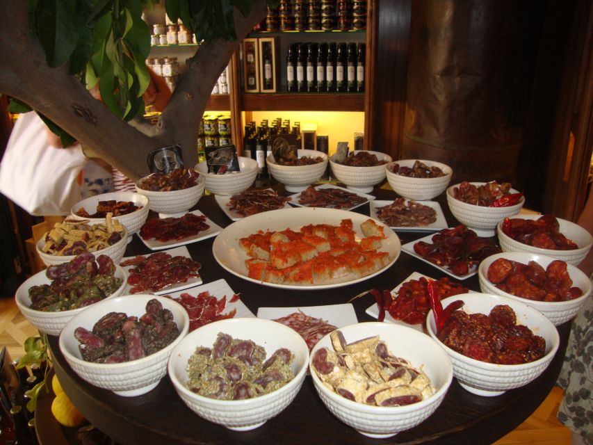 Palma Tour with Wine and Tapas Tasting - Olive oil, ham, cheese, and small plates